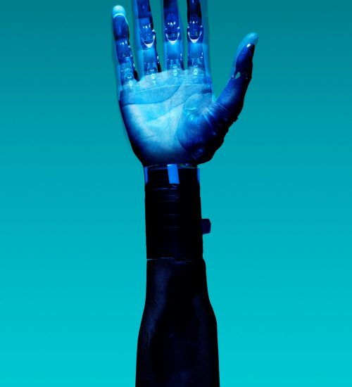 Close-up of a robotic hand showcasing advanced technology against a blue backdrop.