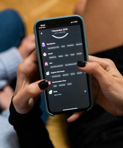 Close-up of woman using a smartphone health tracking app, focusing on personal wellness data.